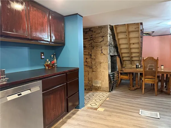 a kitchen with granite countertop a stove and cabinets