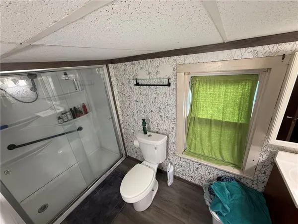 a white toilet sitting next to a shower curtain