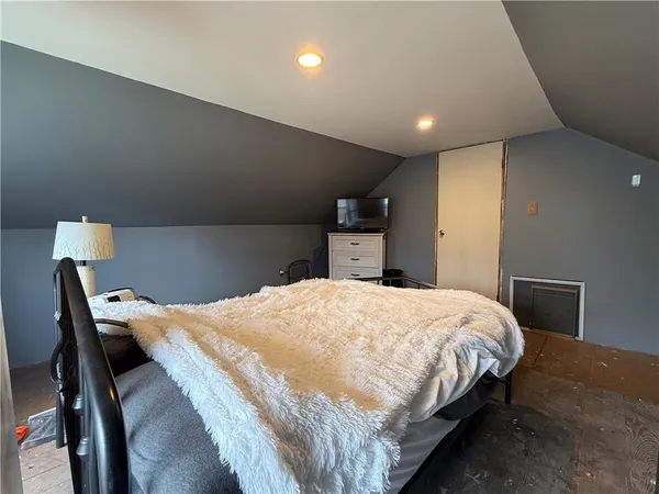 a bedroom with a bed and a desk