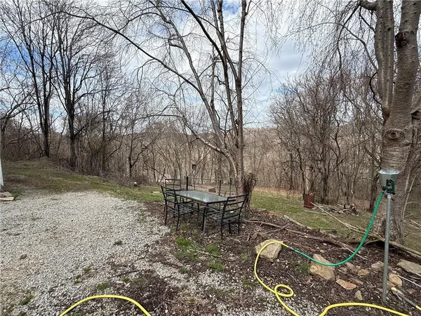 a backyard of a house with table and chairs