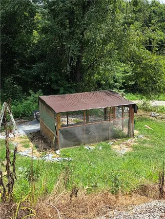 a backyard of a house with yard table and chairs
