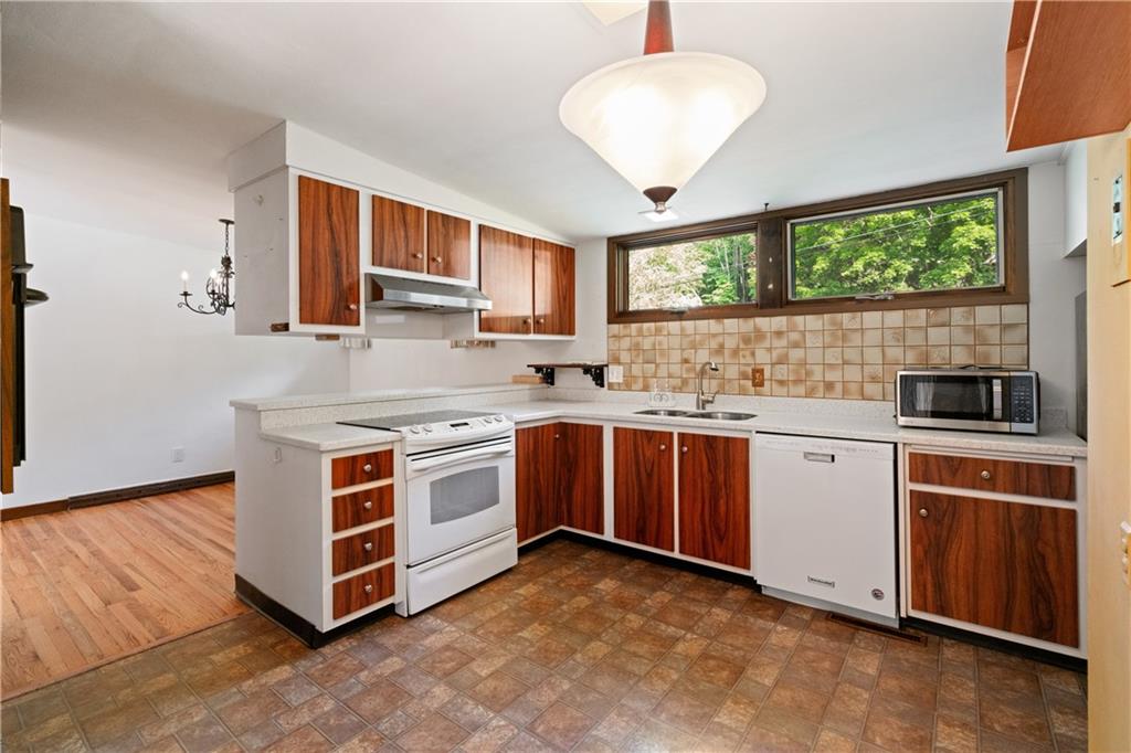 102 Colwyn Road Pittsburgh, PA 15237 - Photo 13 of 29 a kitchen with stainless steel appliances a stove sink and window