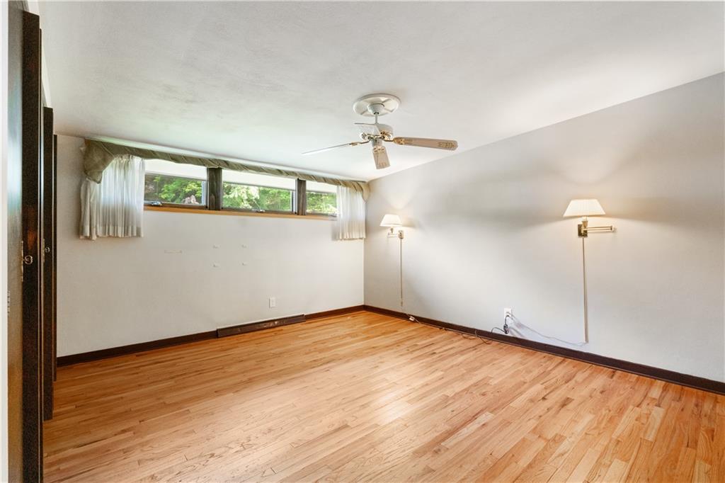 102 Colwyn Road Pittsburgh, PA 15237 - Photo 21 of 29 a view of an empty room with window and wooden floor