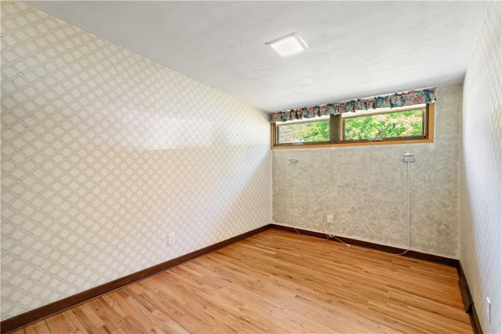 102 Colwyn Road Pittsburgh, PA 15237 - Photo 23 of 29 a view of an empty room with wooden floor and a window