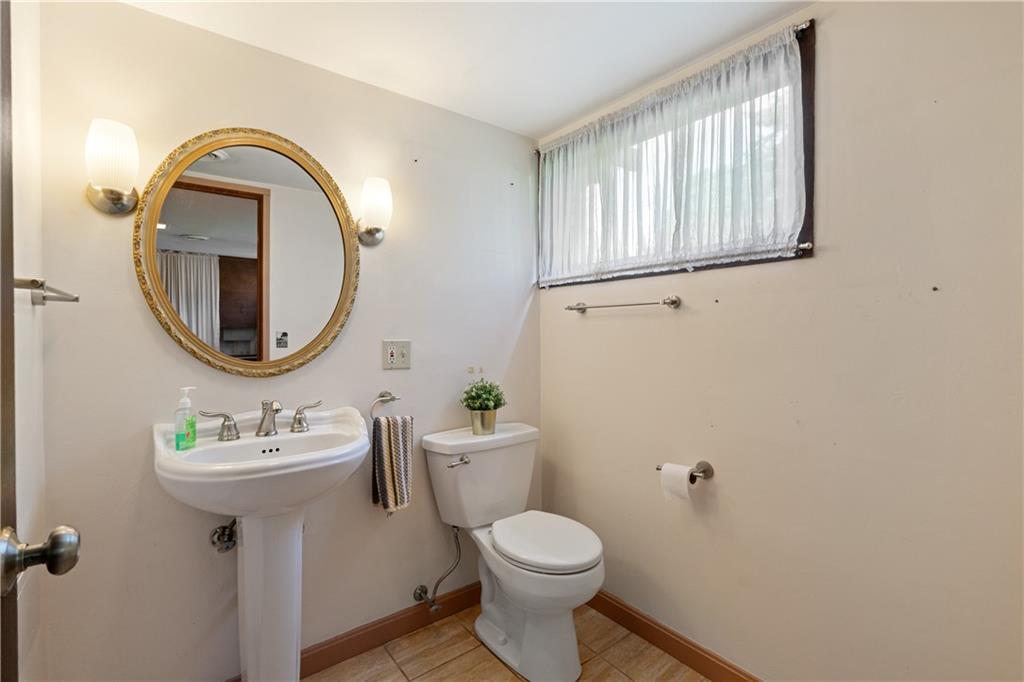102 Colwyn Road Pittsburgh, PA 15237 - Photo 27 of 29 a bathroom with a toilet sink and mirror