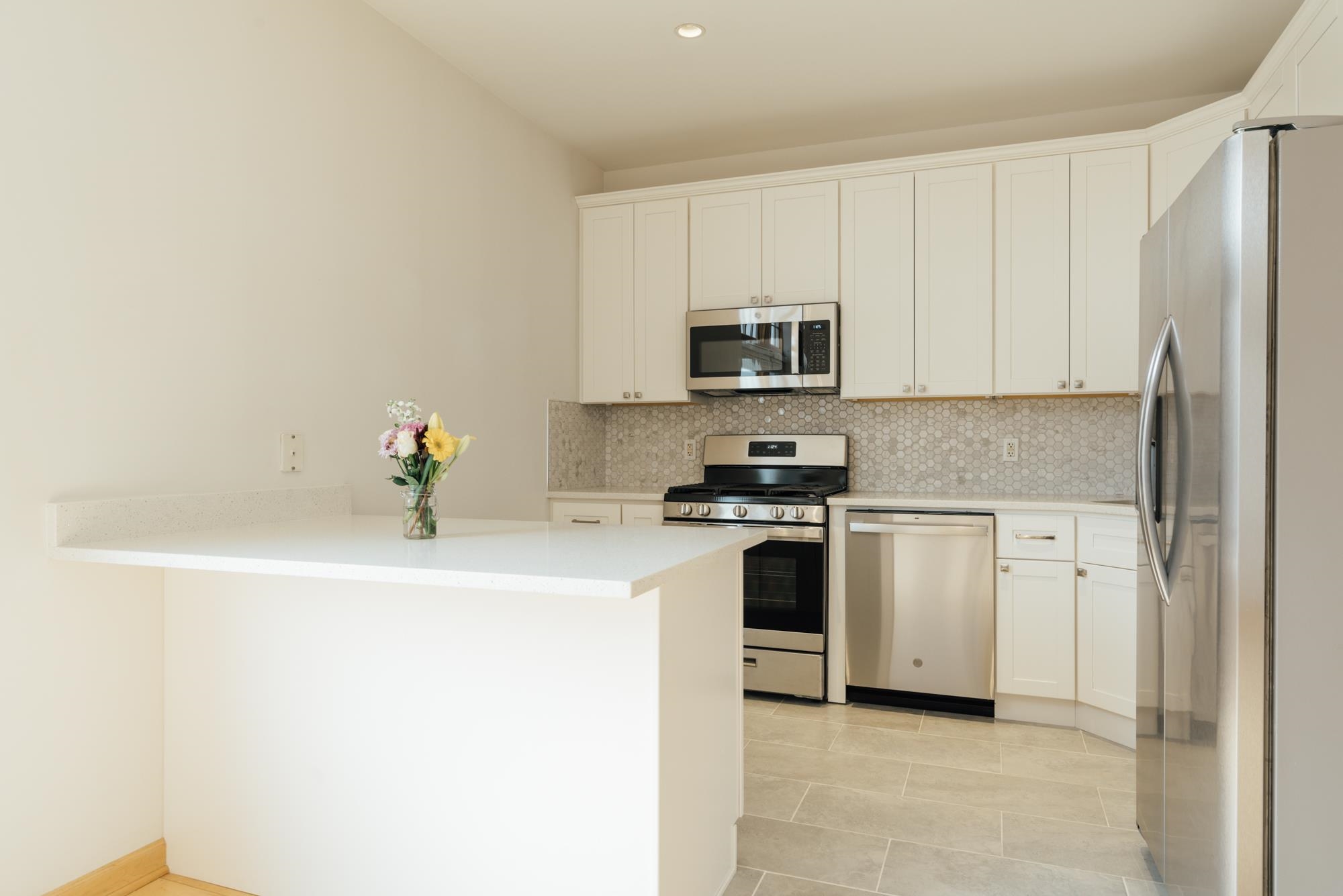 30 Park Avenue, Unit 2 Rutherford, NJ 07070 - Photo 16 of 34 a kitchen with stainless steel appliances a sink a stove a microwave and a refrigerator