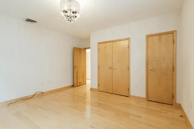 a view of an empty room with closet
