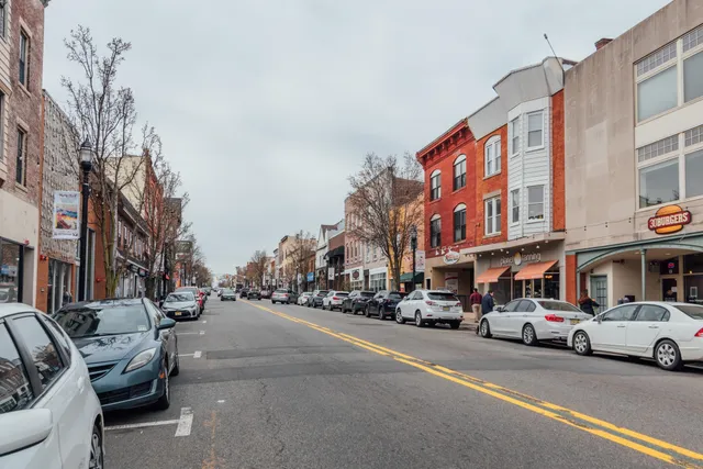 a couple of cars parked in front of a building