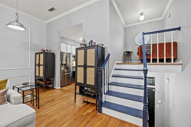 a view of a living room with furniture and wooden floor