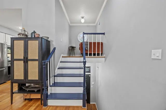 a view of entryway and hall with wooden floor