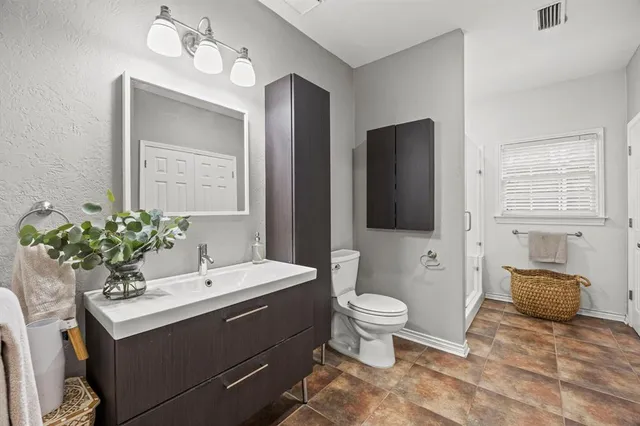 a bathroom with a sink toilet and mirror