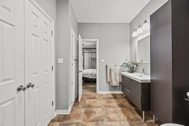 a bathroom with a sink vanity and a mirror