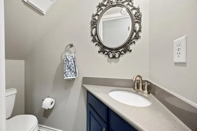 a bathroom with a toilet a sink and a mirror