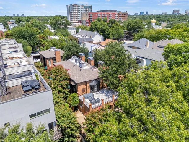 an aerial view of a house with a yard and lake view