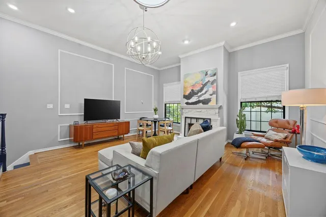 a living room with furniture a flat screen tv and a fireplace