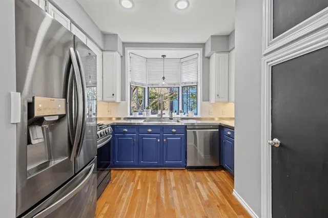 a kitchen with a sink stove and refrigerator