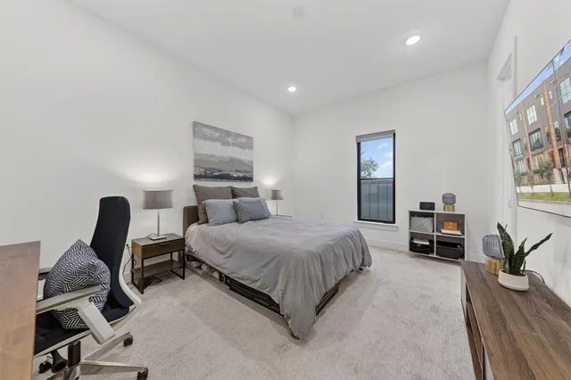 a bedroom with a bed and a desk