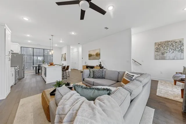 a living room with furniture and kitchen view