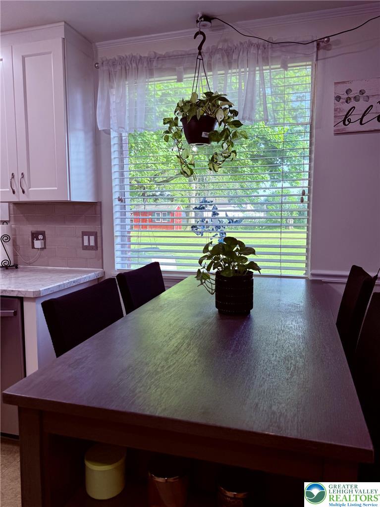 1275 Macada Road Bethlehem, PA 18017 - Photo 38 of 87 A well-lit kitchen area, perfect for daily dining, featuring a modern table and a serene view of the outdoors.
