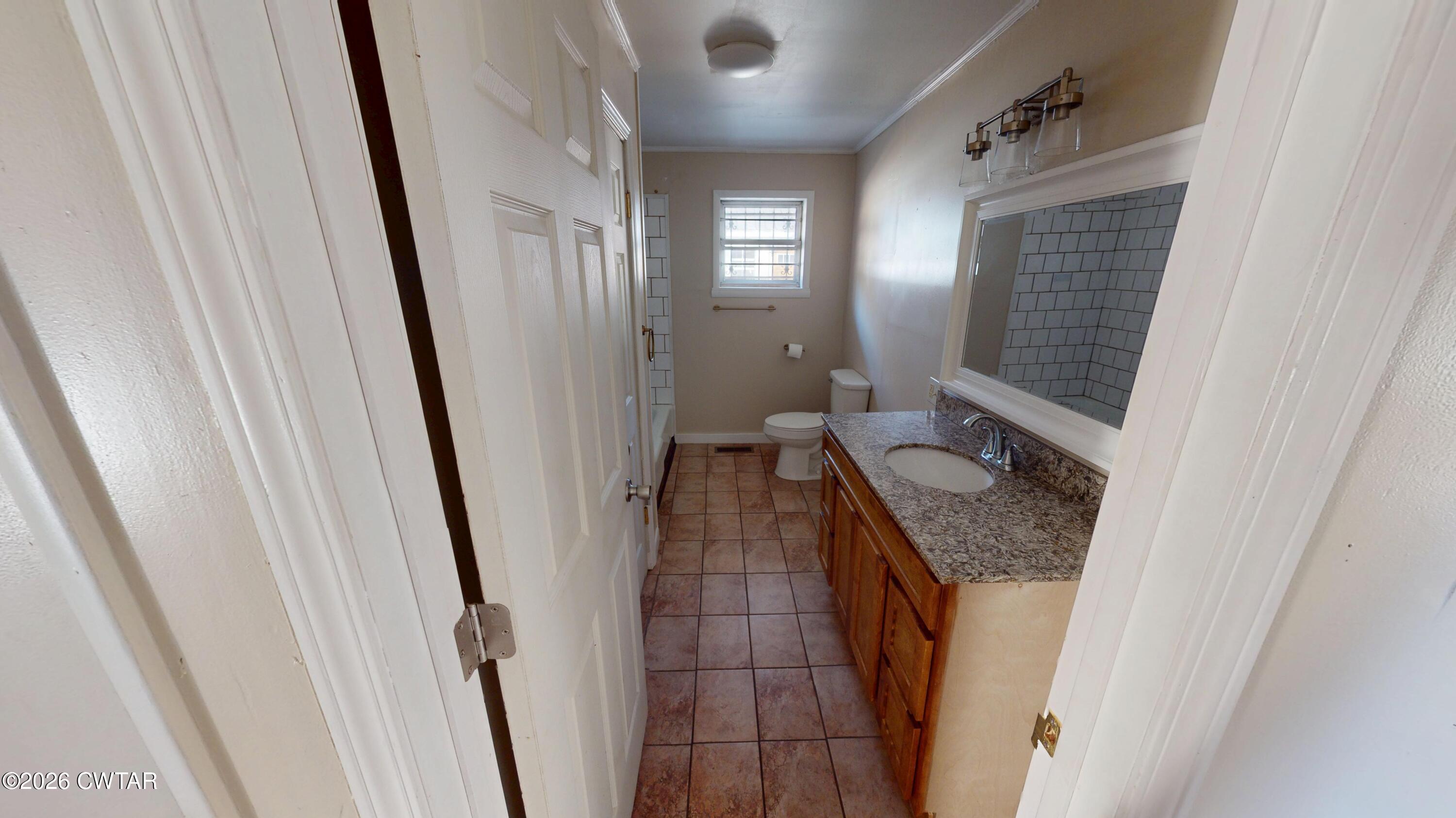 322 Jones Street Newbern, TN 38059 - Photo 15 of 22 a bathroom with a granite countertop sink and a mirror