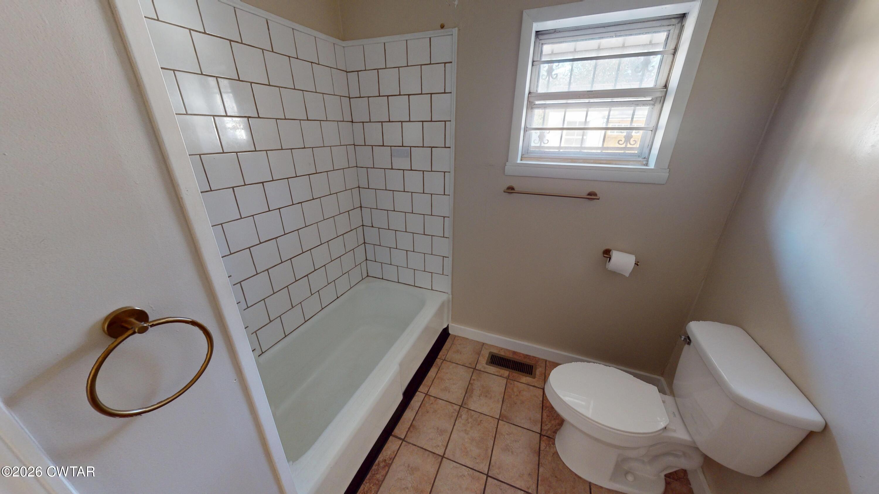 322 Jones Street Newbern, TN 38059 - Photo 16 of 22 a bathroom with a toilet and a shower