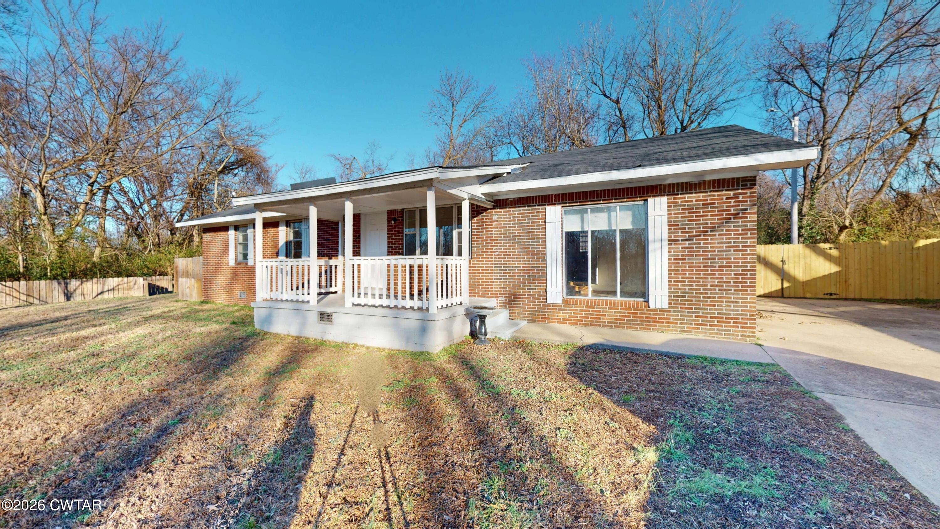 322 Jones Street Newbern, TN 38059 - Photo 2 of 22 a view of a house with a yard and sitting area
