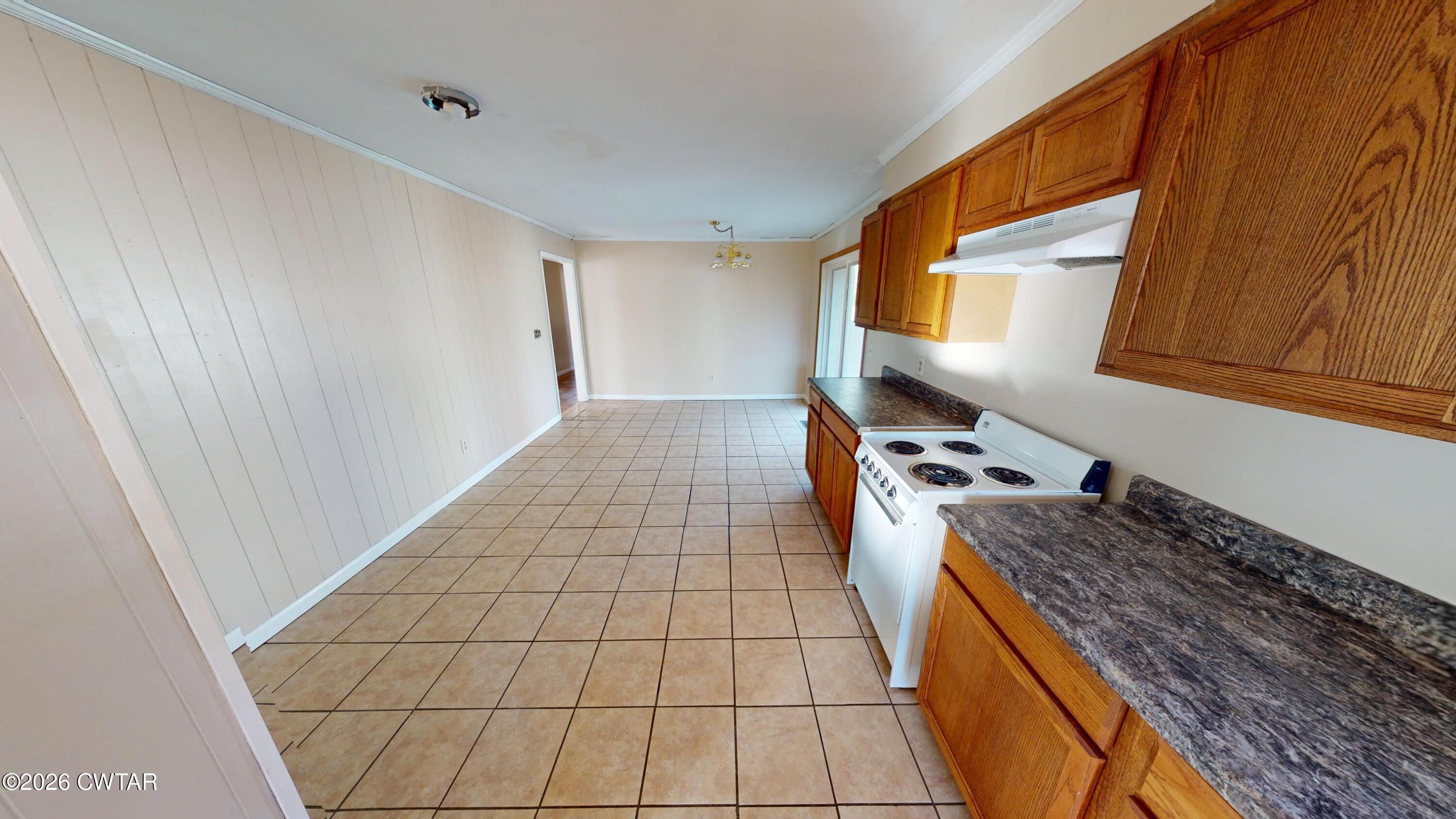 322 Jones Street Newbern, TN 38059 - Photo 7 of 22 a kitchen with a sink a stove and a wooden floor