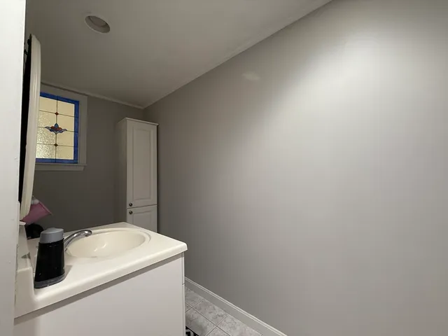 a bathroom with a sink and vanity