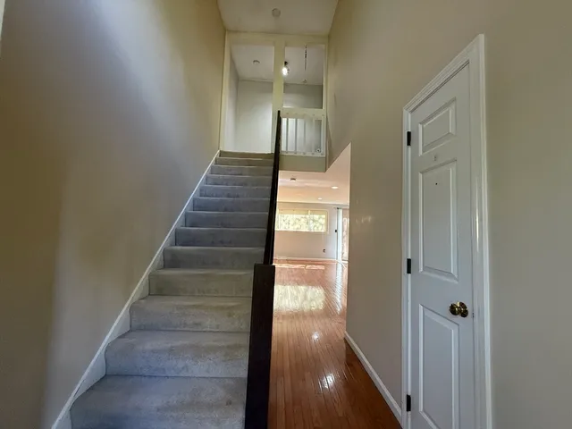 a view of entryway and hall with wooden floor