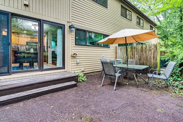 a view of a house with backyard and sitting area
