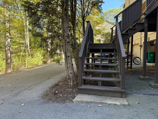 a wooden bench sitting in front of a building
