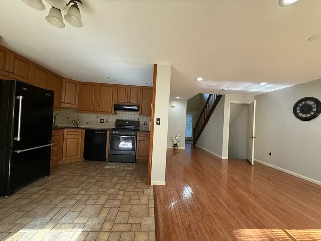 a kitchen with stainless steel appliances a refrigerator and a stove top oven