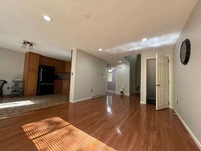 a view of a room with wooden floor and stairs