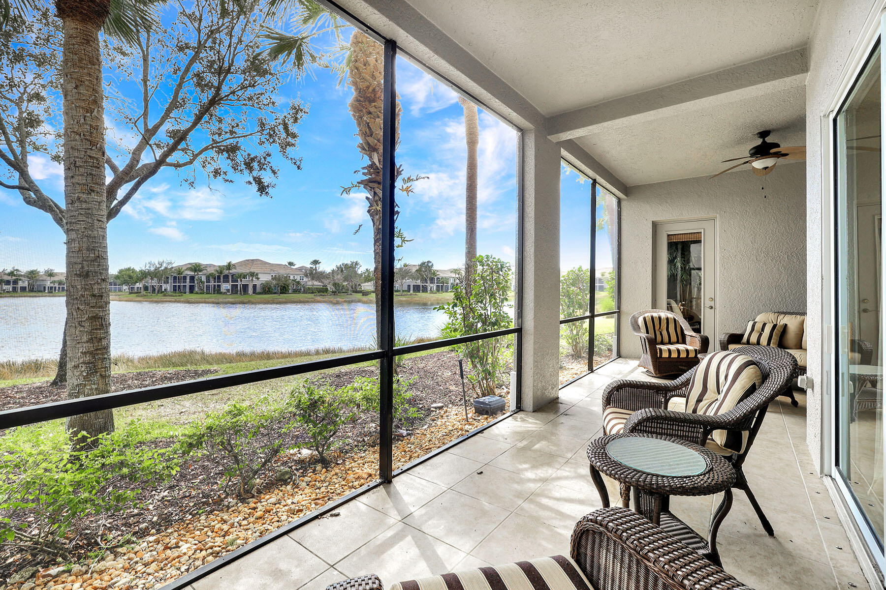 a balcony with furniture and a lake view