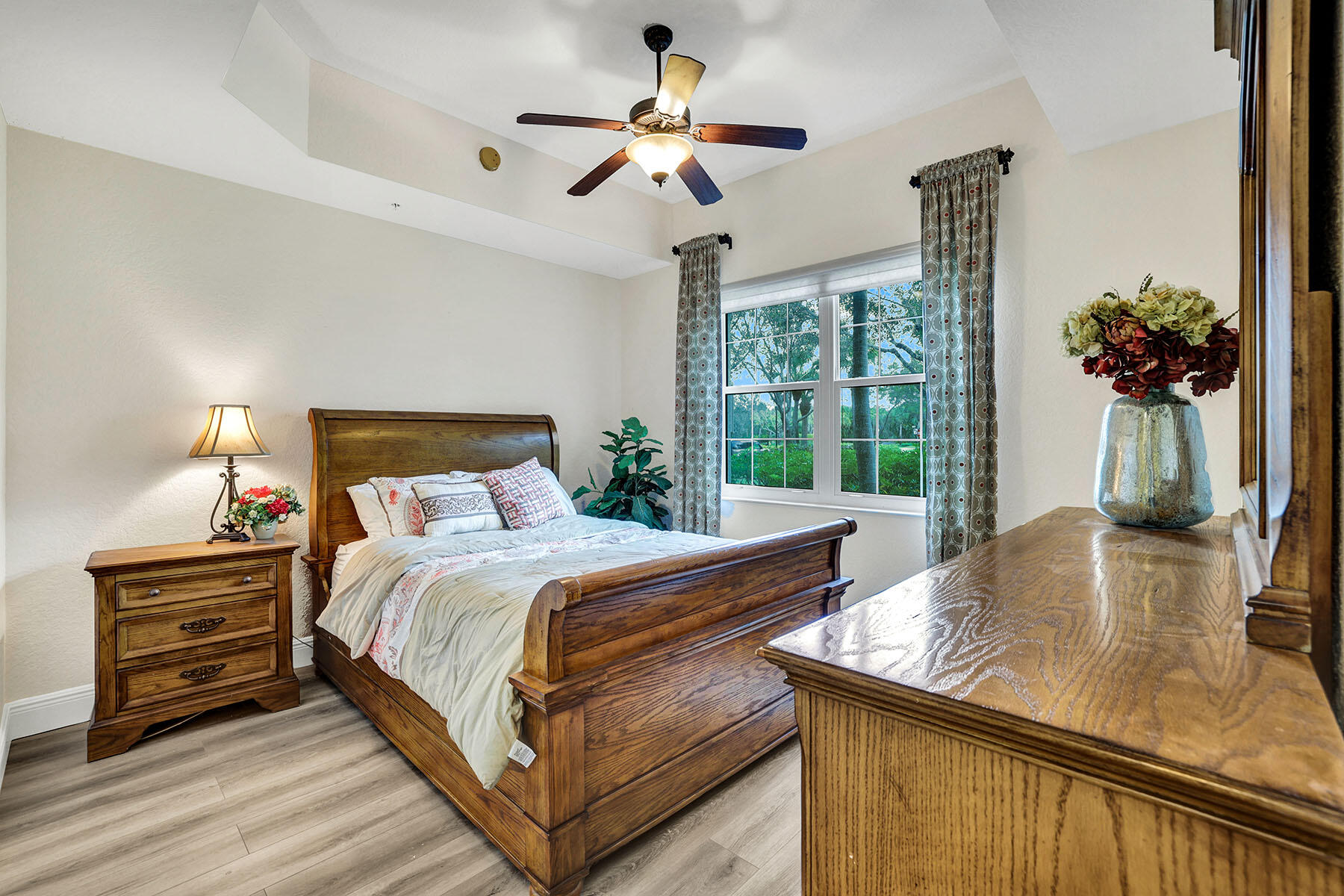 9234 Tesoro, Unit 101 Naples, FL 34114 - Photo 19 of 25 a bedroom with a bed and a chandelier