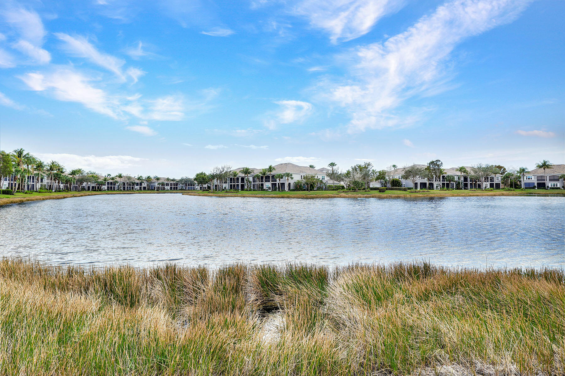 9234 Tesoro, Unit 101 Naples, FL 34114 - Photo 2 of 25 a view of a lake with a city view