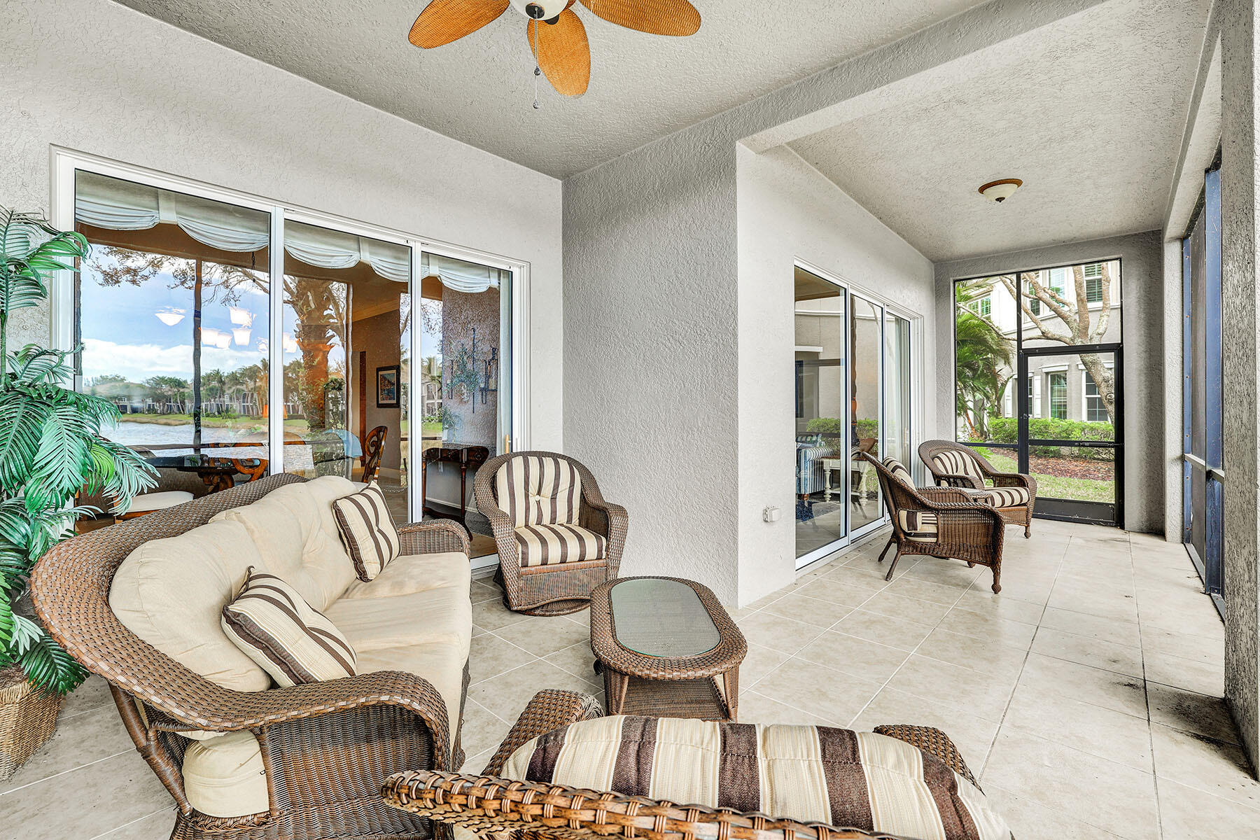 9234 Tesoro, Unit 101 Naples, FL 34114 - Photo 24 of 25 a living room with furniture and a large window