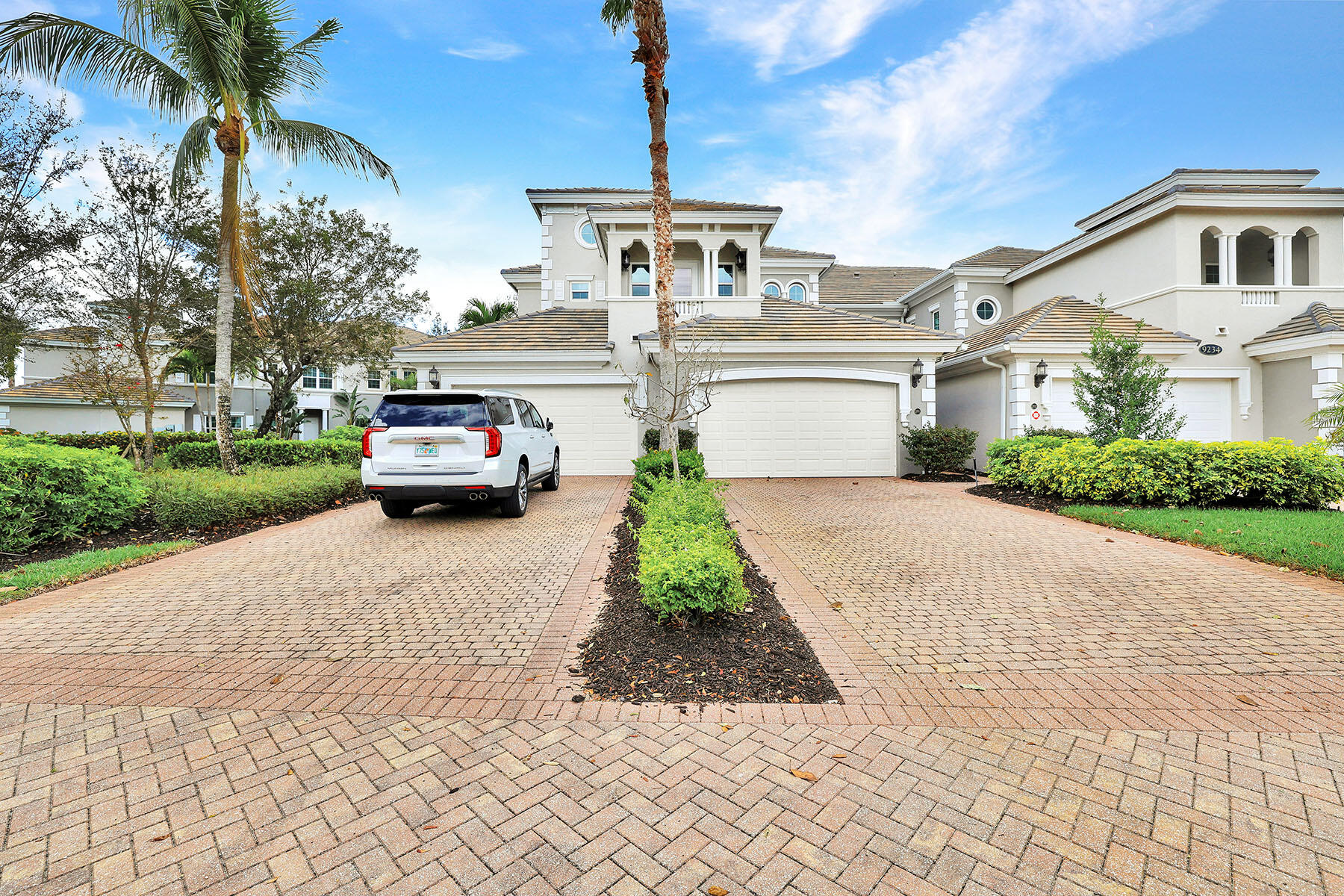 9234 Tesoro, Unit 101 Naples, FL 34114 - Photo 25 of 25 a front view of a house with a garden and trees