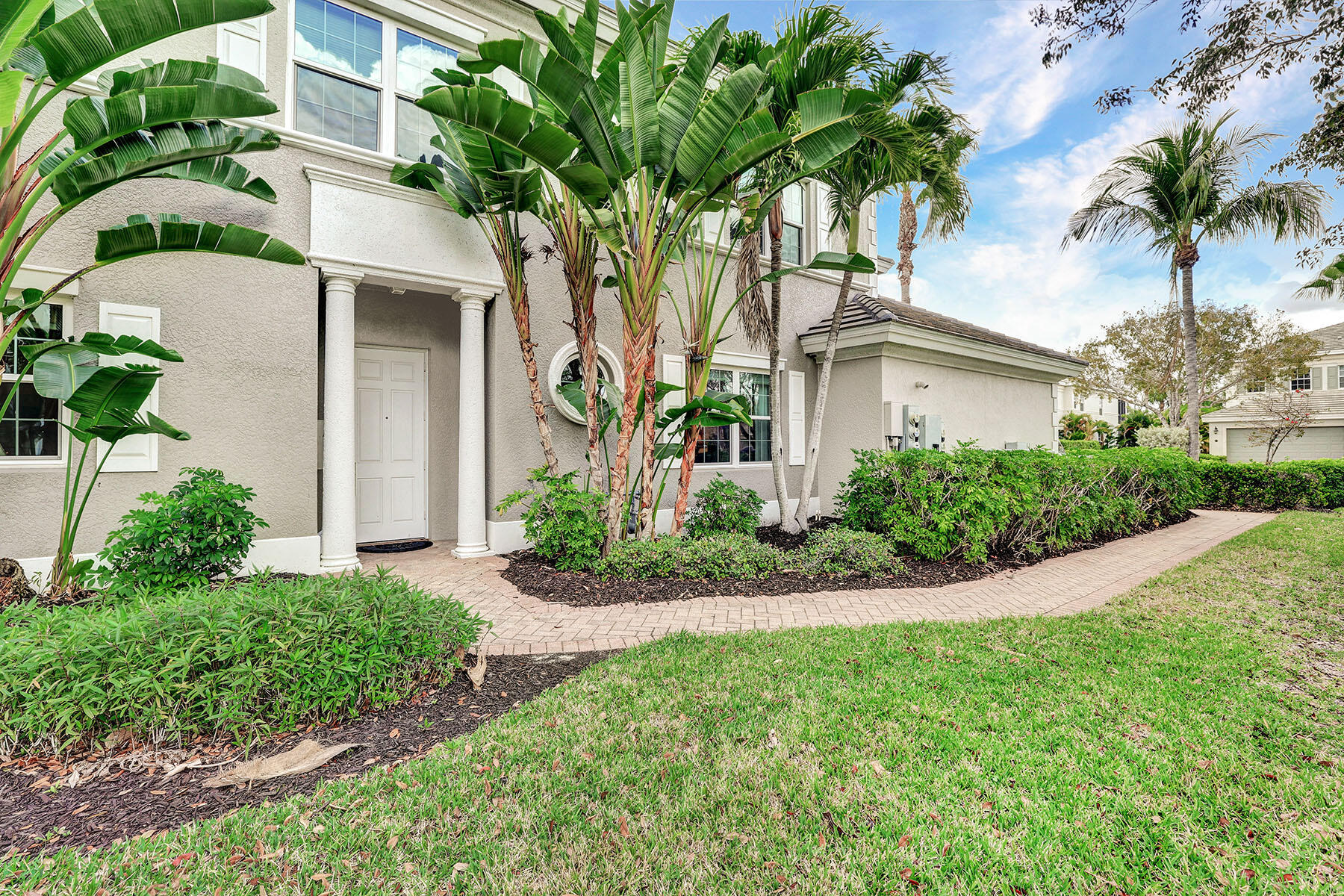 9234 Tesoro, Unit 101 Naples, FL 34114 - Photo 5 of 25 a front view of a house with a garden