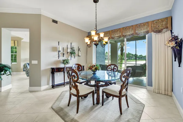 a dining room with furniture a chandelier and window