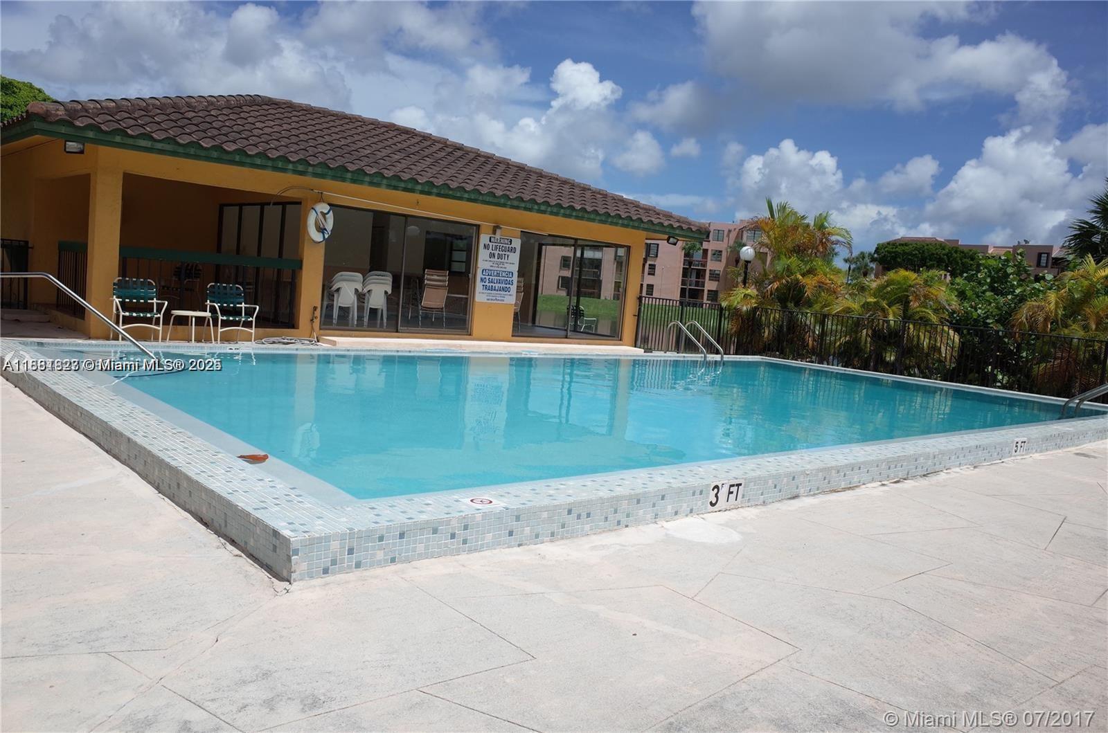 1300 Southwest 122nd Avenue, Unit 4072 Miami, FL 33184 - Photo 2 of 11 an outdoor view of house with swimming pool and outdoor seating