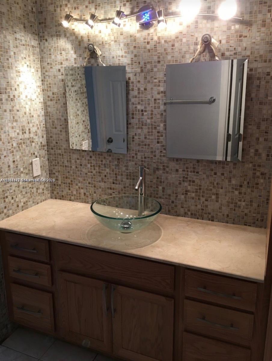 1300 Southwest 122nd Avenue, Unit 4072 Miami, FL 33184 - Photo 9 of 11 a bathroom with a sink and a mirror
