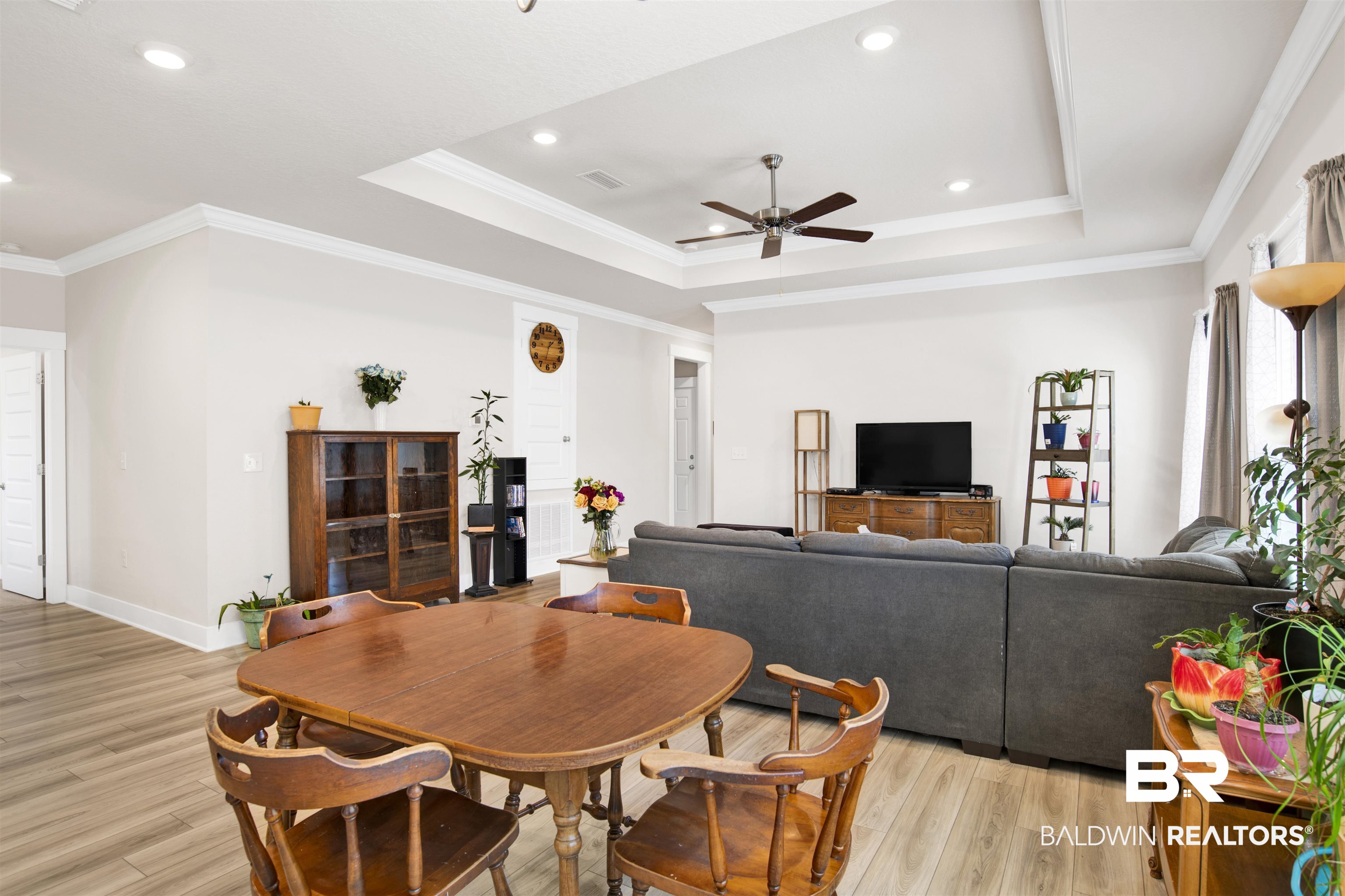 1174 Pheasant Circle Foley, AL 36535 - Photo 9 of 29 Dining room with ornamental molding, a ceiling fan, light wood-type flooring, recessed lighting, and a tray ceiling