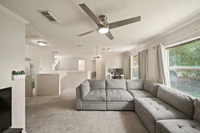 a living room with furniture and a large window