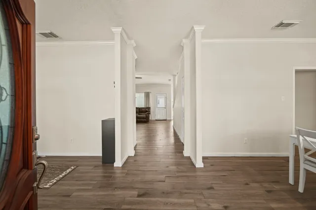 a view of a hallway with wooden floor