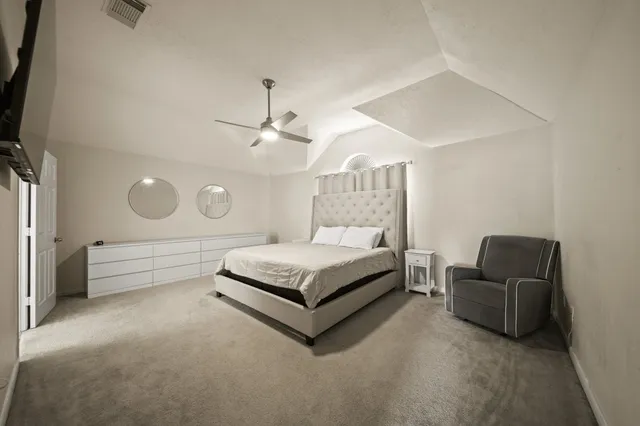 a bedroom with furniture and a flat screen tv