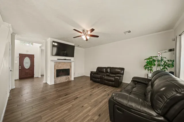 a living room with furniture a fireplace and a flat screen tv