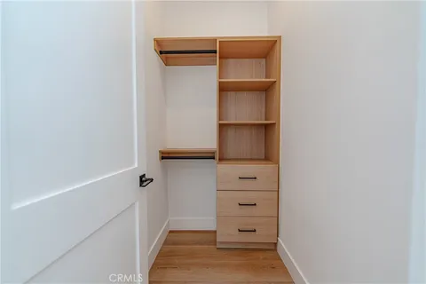 a view of walk in closet with empty racks