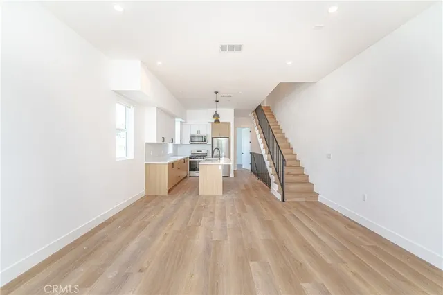 a view of a kitchen with wooden floor