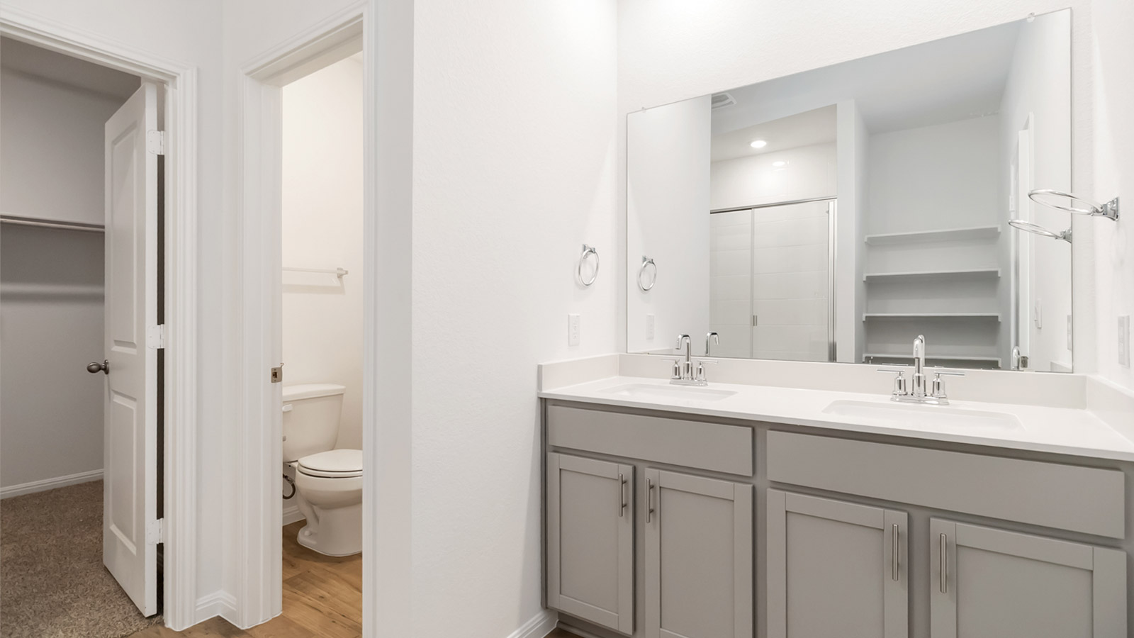 2560 Whittler Road Leander, TX 78641 - Photo 9 of 30 a bathroom with a double vanity sink toilet and mirror